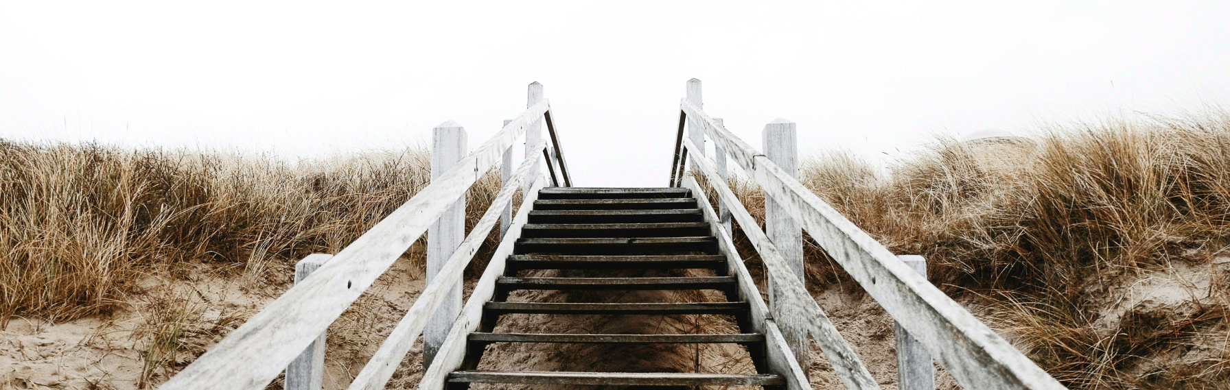A staircase on a sandy dune